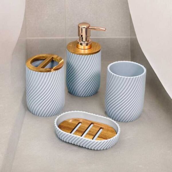 Bathroom soap dispenser set in white and gold with soap dispenser, toothbrush holder, cup and soap holder.