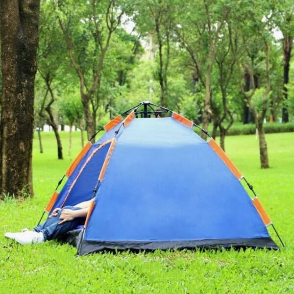 Man enjoying portable camping tent in garden.