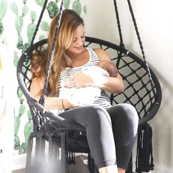 Mom and child relaxing in a swing hammock chair with gentle rocking.