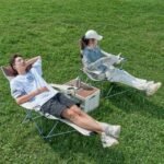 Man and woman using adjustable outdoor reclining chairs.