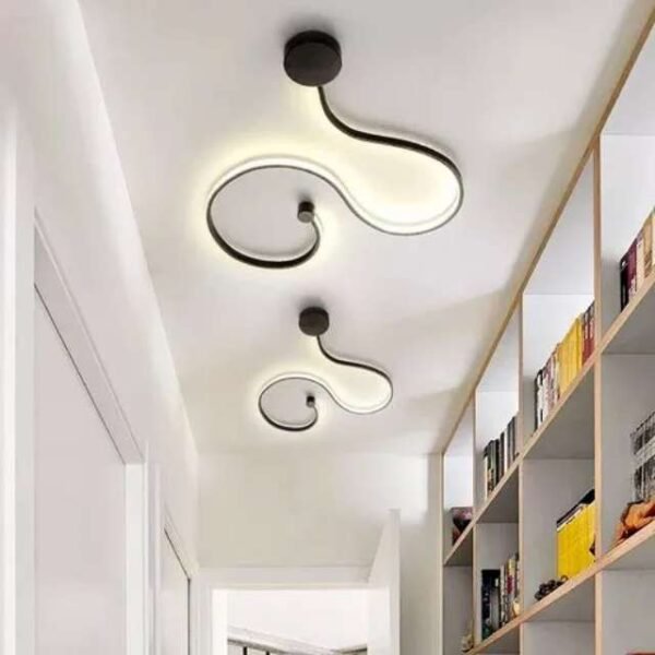 Curved wall light in entryway. Cold white light illuminating a modern entryway ceiling.