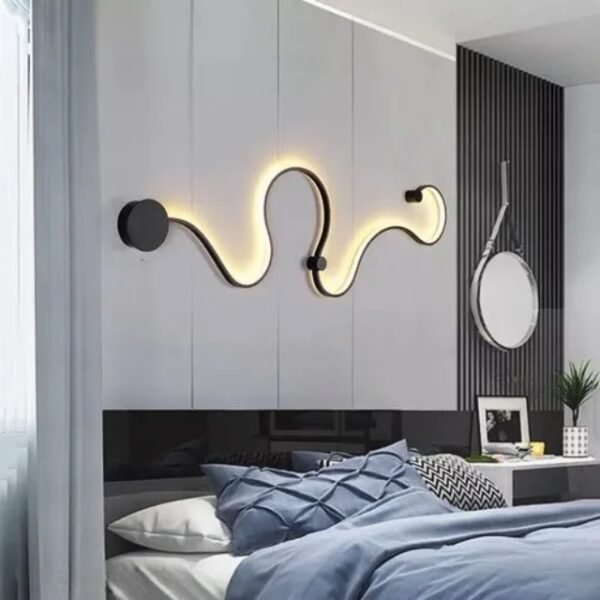 Curved wall light as a statement piece. Modern lamp decorating a bedroom wall.