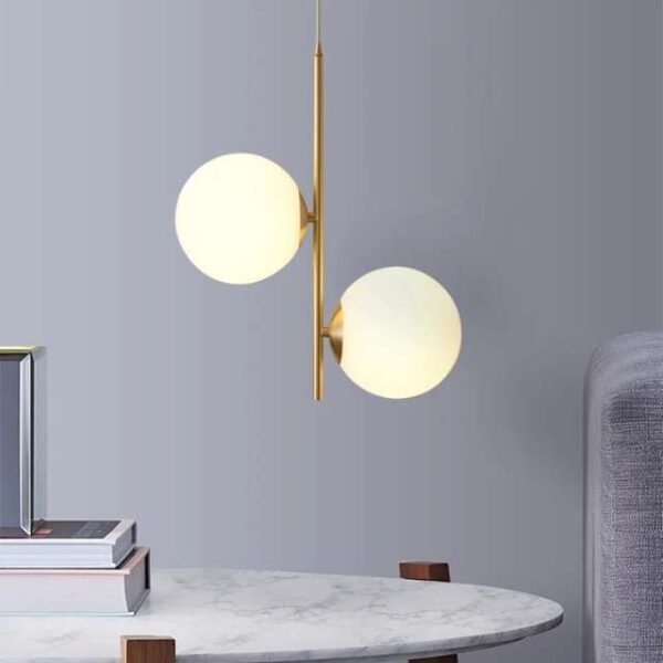 Modern nordic pendant light with two globes casting warm light. Creates perfect ambiance for any space.