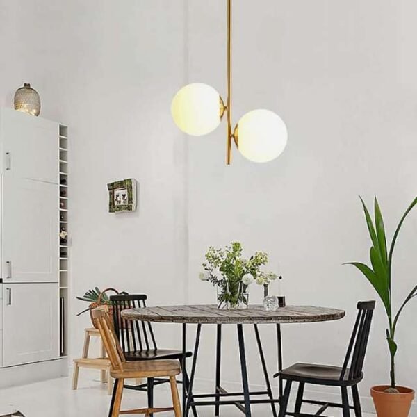 Gold-coated modern nordic pendant light illuminating kitchen with warm glow. Elegant and functional light fixture.