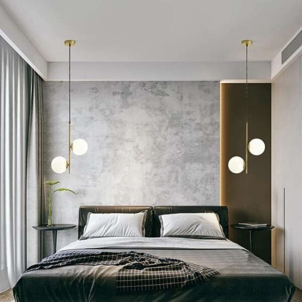 Modern nordic pendant light in bedroom above bedside table. Provides enchanting ambiance with two white globes.