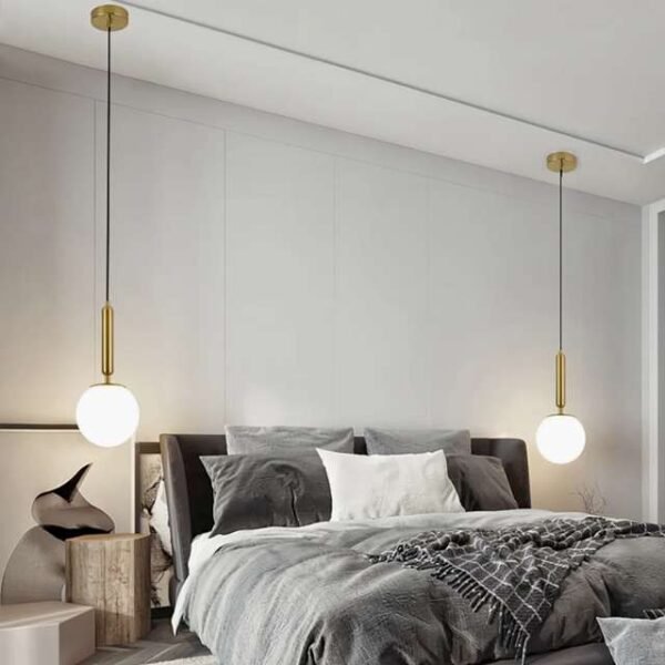 Two modern pendant light fixtures illuminating bedroom ceiling.