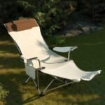 Beige outdoor reclining chair in garden with headrest and armrest.