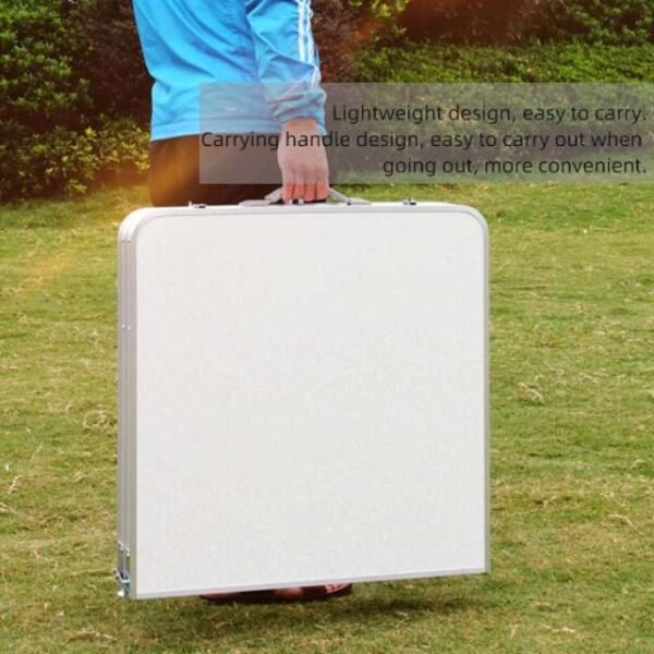 Man holding height-adjustable picnic table set outdoors.