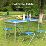 Picnic table set with four foldable chairs in nature.