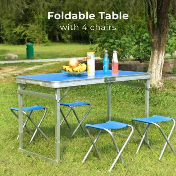 Picnic table set with four foldable chairs in nature.