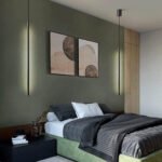 Two slim pendant lights hanging from a bedroom ceiling, showcasing adjustable LED light.