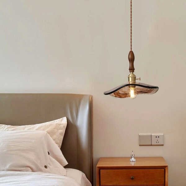 Vintage pendant light creating a warm, inviting atmosphere in a bedroom.