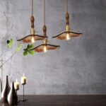 Three vintage wall lamps with amber fittings casting a warm light.