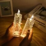 Elegant flameless LED candle lamp with diamond-patterned design held by hands.