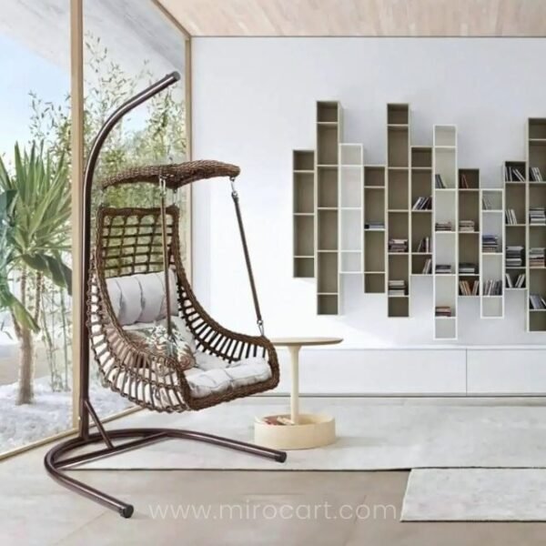 Hanging brown egg chair in living room with light grey cushion and handcrafted rattan design.