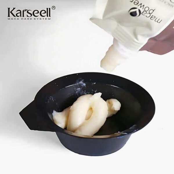 Squeezing Karseell Hair Treatment Cream to show its rich texture.