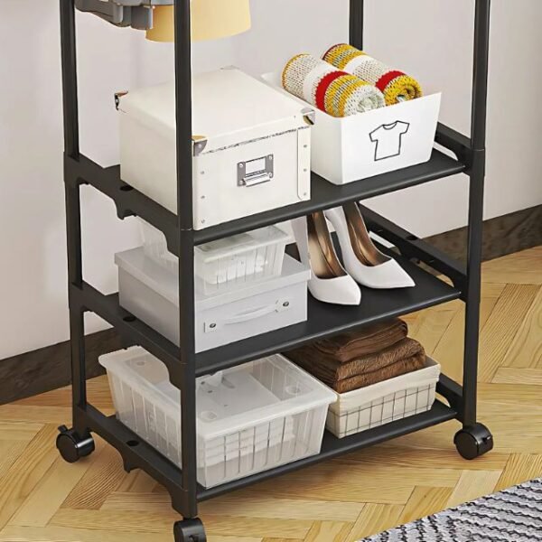 Zoomed-in view of 3 storage shelves on minimalist clothes rack for shoes and boxes.