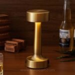 Golden table lamp on bar casting warm ambiance with sleek finish.