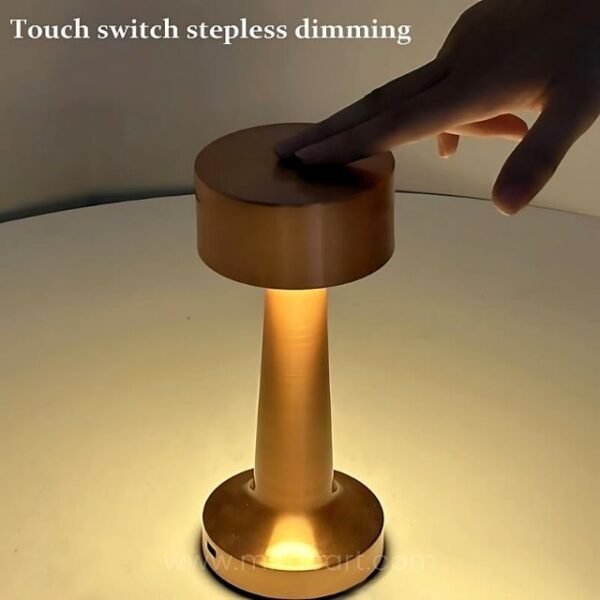 Man demonstrating brightness control on the minimalist golden table lamp.