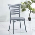 Grey minimalist Nordic dining chair with slatted backrest placed on a white floor, adding elegance to a modern space