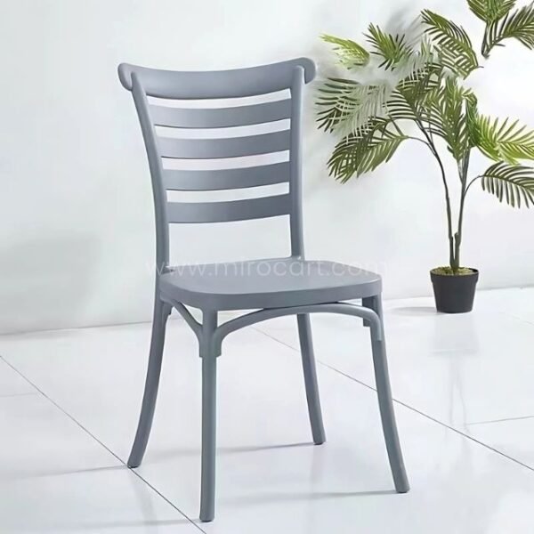 Grey minimalist Nordic dining chair with slatted backrest placed on a white floor, adding elegance to a modern space