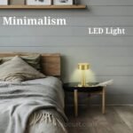 Golden table lamp on bedside table providing warm, inviting glow.