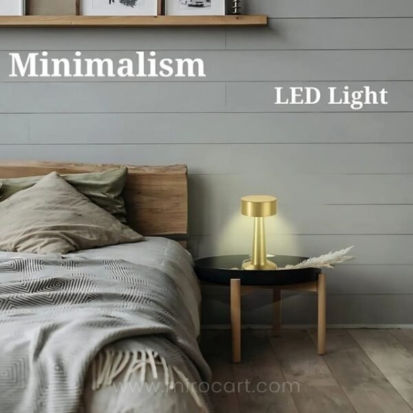 Golden table lamp on bedside table providing warm, inviting glow.