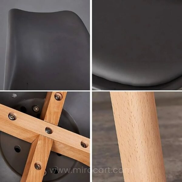 Close-up of modern dining chair showing curved design, padded seat, and wooden legs.