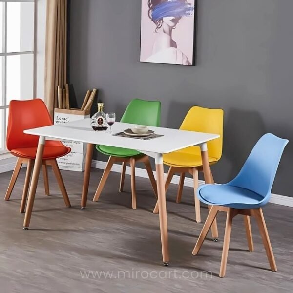 Multicolored modern dining chairs in red, green, yellow, and blue around a dining table.
