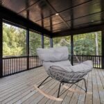 Rocking egg chair in sleek gray, placed on patio for relaxing outdoor moments.