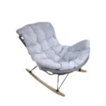 Handcrafted rattan rocking egg chair with wooden legs and soft cushion for comfort.
