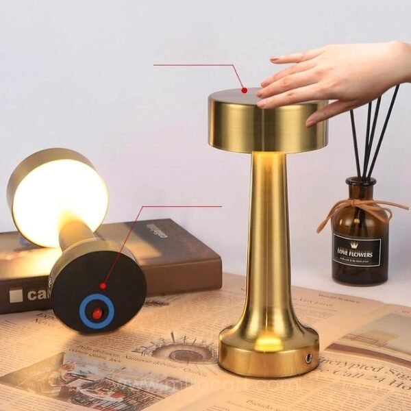 Woman adjusting the brightness of the minimalist golden table lamp with a tap.