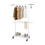 White extendible clothes rack on wheels with various garments, a striped storage box, and grey sneakers on the bottom shelf.