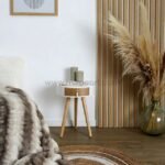 Minimalist bedside table with candles in a cozy interior.