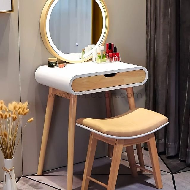 Modern dressing table with white round top, wooden legs, and makeup items.