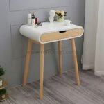 Modern dressing table with white top, wooden drawer, and decorative items.