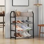 Black 4-tier shoe rack with a sleek design, neatly holding shoes and a wicker basket in a cozy room with wooden flooring and warm decor.