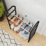 Sleek black and white shoe rack with a sturdy frame, holding three pairs of neatly placed shoes in a simple, stylish setting.