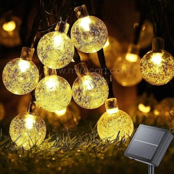 Warm white globe solar string lights with a textured finish, providing elegant and energy-efficient outdoor illumination.