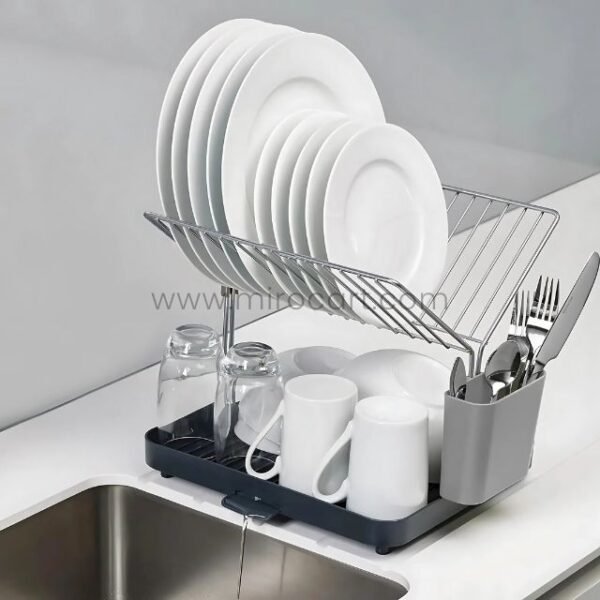 Neatly arranged 2-tier dish rack by sink with plate slots and cutlery compartment.