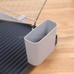 Practical dish rack with ribbed base and side-mounted utensil organizer.