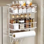 White spice rack holding jars, oils, and tools on a fridge side.