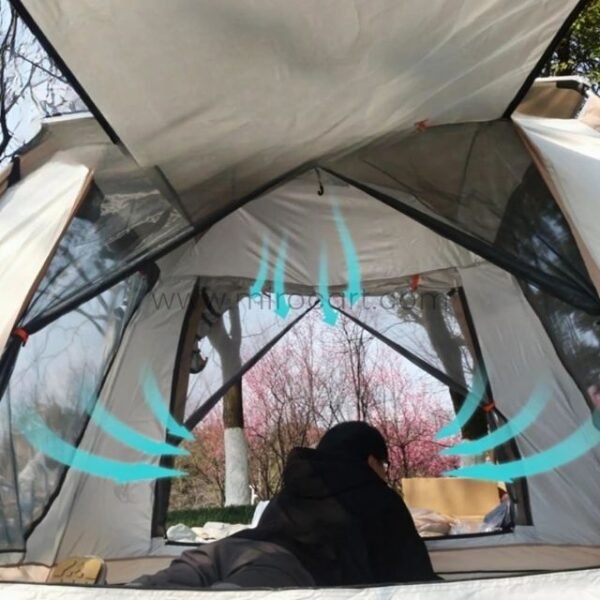 Interior of a camping tent with mesh windows and doors, showing airflow with blue arrows.