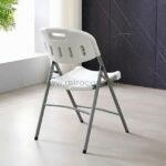 Stylish white foldable chair in a bright room with sleek decor. Perfect for compact, practical seating.