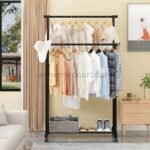 Black metal double pole clothes rack with two rods, holding jackets, shirts, and accessories on wooden hangers, with extra space for shoes and bags below.