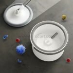 Hands-free spin mop surrounded by colorful germ representations on a dark floor.