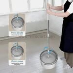 Hands-free spin mop being used with a bucket featuring a built-in wringer for rinsing and drying.