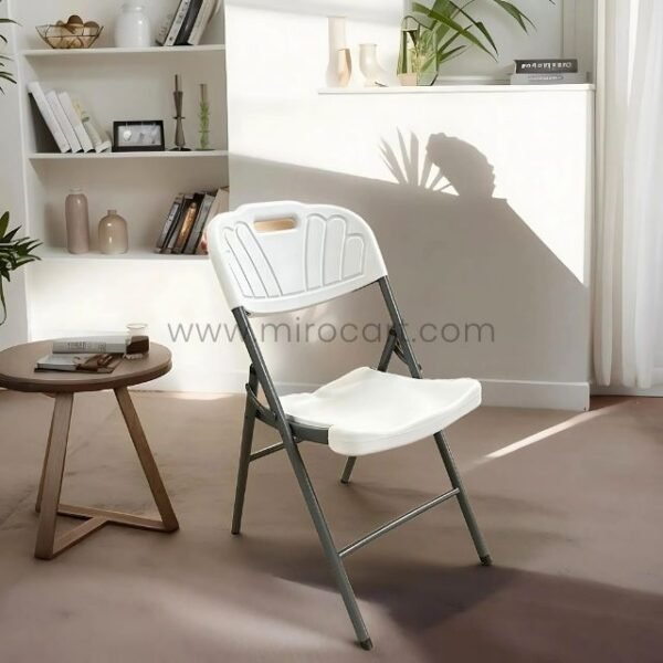 Heavy-duty white foldable dining chair in a sleek modern room. Lightweight and multipurpose for home or events.