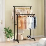 Double pole clothes rack with two adjustable poles holding jackets and shirts, plus a bottom shelf for shoes and bags, creating a tidy and stylish space.