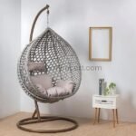 Grey rattan egg chair with soft pillow and thick cushion in a reading nook, perfect for curling up with a book